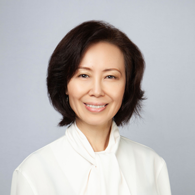 A dark haired woman in a white shirt